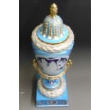 A large continental vase, cover and plinth, turquoise ground with a pate sur pate relief of