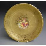 A Royal Worcester acid etched gilded cabinet plate with a central reserve painted with fruit signed