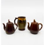 Two Staffordshire brown lustre small teapots with widow finial; one with twist handle approx 13.5
