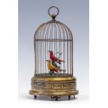 An early 20th Century brass bird cage musical automaton, with a pair of birds on a branch, key
