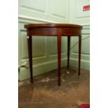 A George III mahogany and inlaid card table, of demilune form, raised on square tapered legs