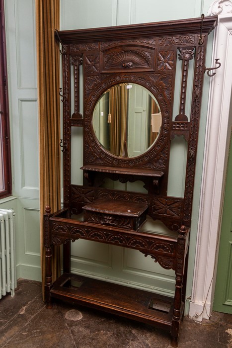 A Victorian oak hall stand, having a mirrored back