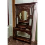 A Victorian oak hall stand, having a mirrored back