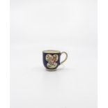A Worcester coffee can, exotic birds pattern, blue crescent mark to base, approx. 6cm high.