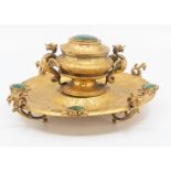 A 19th Century gilt metal ink stand set with malachite, circular form with chased foliate scroll