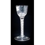 An 18th century opaque twist wine glass, the ogee bowl with moulded half fluting, on a multi