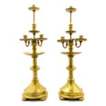 A pair of late 19th Century brass candle holders attributed to John Hardman Powell, each for three