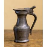 17thC Pewter A small lidded pewter jug, double acorn finial, part worn touch marks to base, H 13cm.