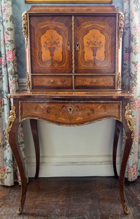 A 19th Century French marquetry cabinet on stand, applied ormolu mounts, the upper section fitted