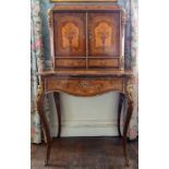 A 19th Century French marquetry cabinet on stand, applied ormolu mounts, the upper section fitted