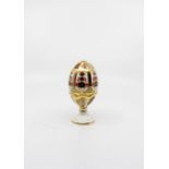 A Royal Crown Derby Imari 1128 pattern egg and stand, first quality, egg has gold stopper, 15 cms
