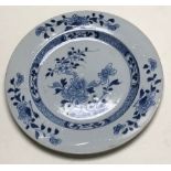 A Chinese Nanking Cargo blue and white plate, 18th Century, decorated with a tree and a foliage