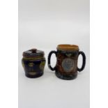 A Royal Doulton stoneware twin handled tankard commemorating Lord Nelson, the handles fashioned as