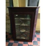 A 19th Century mahogany wall hanging corner cabinet, single glazed door, 108cm high