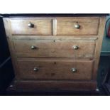 A Victorian pine three drawer chest, with brass handles, raised on bun feet, together with a further