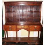 A mid 18th Century oak dresser with rack