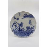 A Japanese porcelain lobed edged charger, blue and white transfer printed with scene of lilies and