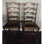 A pair of 19th Century side chairs, of regional design, ladder back form, upholstered seats (2)