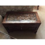 A Chinese hardwood carved camphor chest, carved top, front and sides, 49cm high, 80cm wide, 42cm