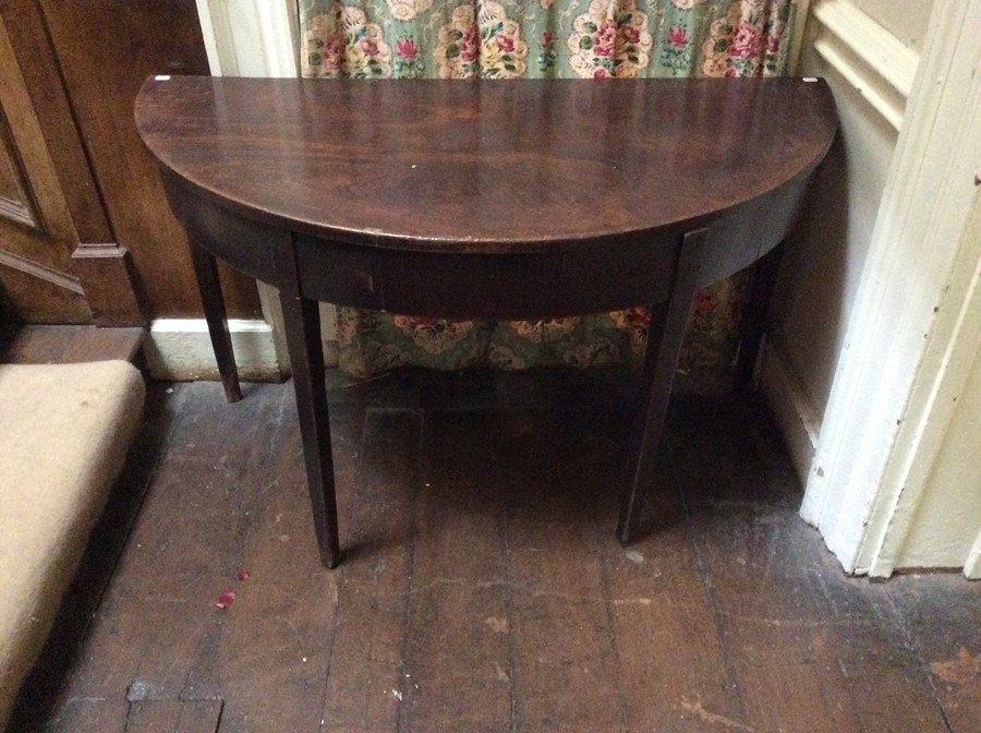 A George III mahogany demilune table, circa 1800, originally the end section of a larger dining