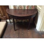 A George III mahogany demilune table, circa 1800, originally the end section of a larger dining