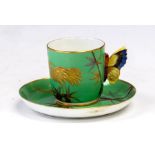 A Royal Worcester coffee can and saucer, painted in green with a bird and a branch in the