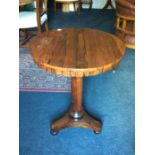 An early 19th Century rosewood pedestal wine table, turned column and standing on a triform base,