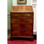 A George III style mahogany bureau, of small proportions, the fall front opening to reveal a fitted