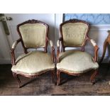 A pair of 19th Century French open armchairs, carved crest rails, raised on French cabriole legs (