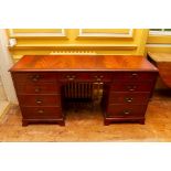 A Georgian style kneehole dressing table with a centre drawer and four drawers either side, of