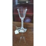 An 18th century opaque twist wine glass, the round funnel bowl on a multi strand helix and central