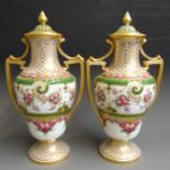 A pair of Copeland vases and covers, with gilded twin handles, the vases painted with pink roses and