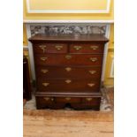 A George II oak chest of drawers on earlier stand