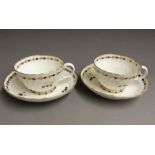 Two Worcester fluted tea cups and saucers with blue and gilt sprig decoration, circa 1780, later