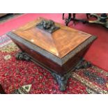 An early Victorian mahogany wine cooler, carved top, carved edge, sarcophagus form, the lid