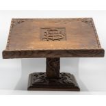 A carved wooden table top lecturn
