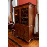 A George III mahogany secretaire linen press, the upper section with a fretwork geometric moulded