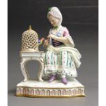 A Meissen figure of Touch, one of the five Senses, the young lady is seated by a birdcage, her pet