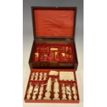 An early 20th Century Canton ivory chess set, comprising thirty two pieces in the natural and