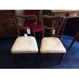 A pair of Victorian oak button back fireside chairs, red upholstered seats and backs, raised on