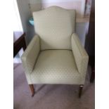 An Edwardian green upholstered bergere upholstered bergere chair