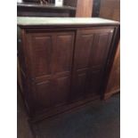 A late Victorian oak side cupboard, fitted with two doors, enclosing adjustable shelves, 138cm high,