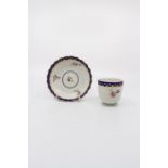 A Chelsea Derby coffee cup and saucer, painted with floral sprigs and blue and raised gilt