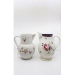 Two large Derby porcelain jugs decorated with flowers, including a mask jug with gilt grape and vine