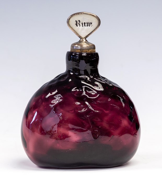 A 19th Century amethyst glass decanter, dimple body, broken pontil base, with two mother of pearl