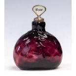 A 19th Century amethyst glass decanter, dimple body, broken pontil base, with two mother of pearl