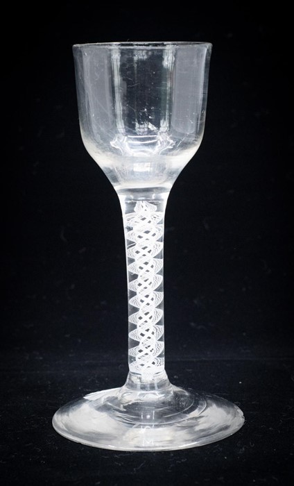 An 18th century opaque twist wine glass, the ogee bowl on a double lattice and double helix core