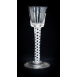 An 18th century opaque twist wine glass, the bucket bowl on a double helix, multi strand stem, on