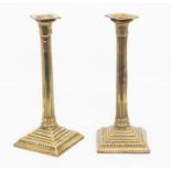 A pair of 18th century brass candlesticks, Roman Doric columns on square stepped bases, detachable