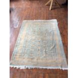 A turquoise and brown geometrical patterned hand knotted woollen rug, 26cm wide x 182cm long